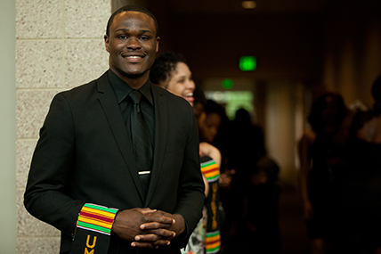 adult man posing with hands clasped at the Umoja: Black Graduation Celebration