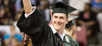 Male student in cap and gown at commencement